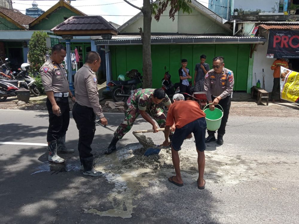 Warga Bersama TNI-Polri Cegah Kecelakaan, Tambal Jalan Berlubang di Kota Malang